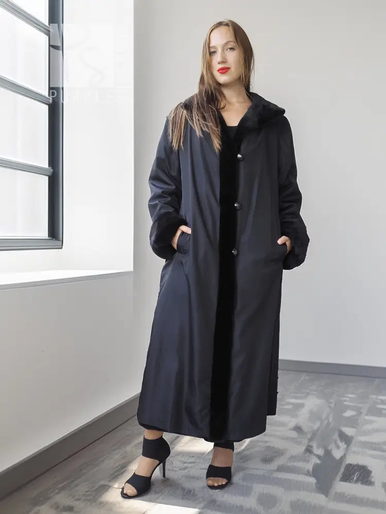 Long black mink coat with button front and full sleeves, front view