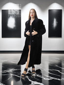 Black mink coat with button front and long length, open over dress hem