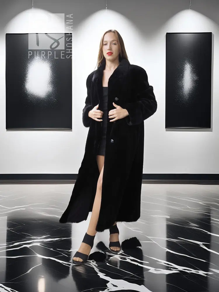 Black mink coat with button front and long length, open over dress hem