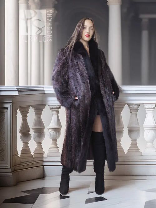 Long beaver fur coat in dark tone with fox-fur collar, cuff trim, and button front.