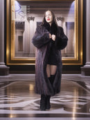 Long dark fur coat with voluminous sleeves and open front over a short dress