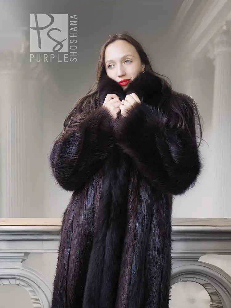 Dark long fur coat with high collar, plush cuffs, and open front near the neck