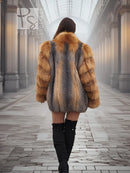 Back view of fur jacket with orange sleeves and grey center panel.