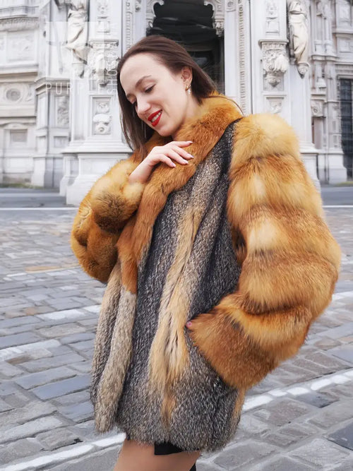 Fox-fur style jacket with orange-brown and gray panels, wide sleeves, and plush collar.