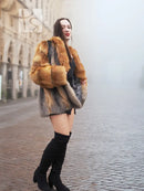 Two-tone fox fur jacket with orange-red sleeves and grey torso, open front