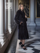 Black mink full-length coat with high collar, button front, and long sleeves.
