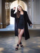 Full-length dark mink coat with open front and wide fur collar, flowing hem.