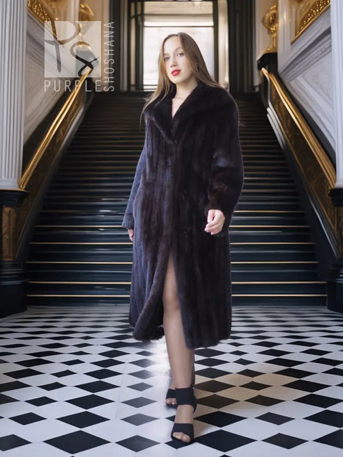 Black mink full-length coat with side-slit hem and structured, textured fur finish.