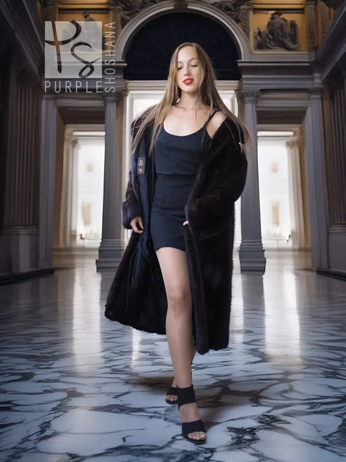 Full-length dark mink coat with open front and layered, flared hem at the bottom.