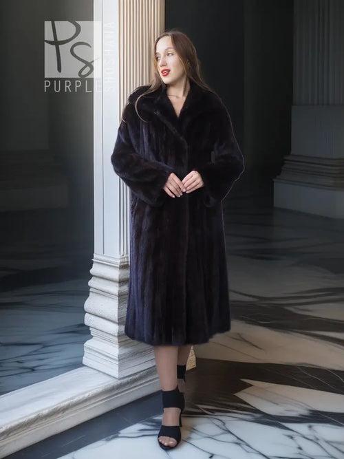 Black mink full-length coat with V-neck, straight skirt, and side-slit detailing.