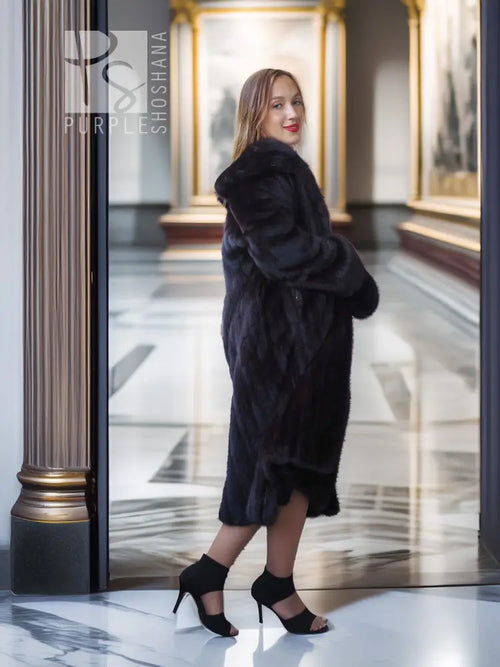 Full-length dark mink coat with open front and draped sleeves in a side view.