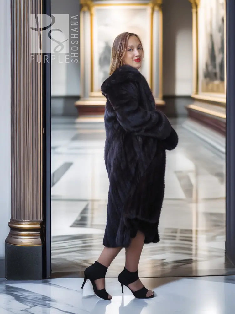 Full-length dark mink coat with open front and draped sleeves in a side view.