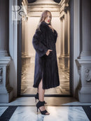 Black mink full-length coat with hooded collar and open front over the skirt hem.