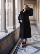 Black mink full-length coat with hooded neckline and side-slit skirt hem.