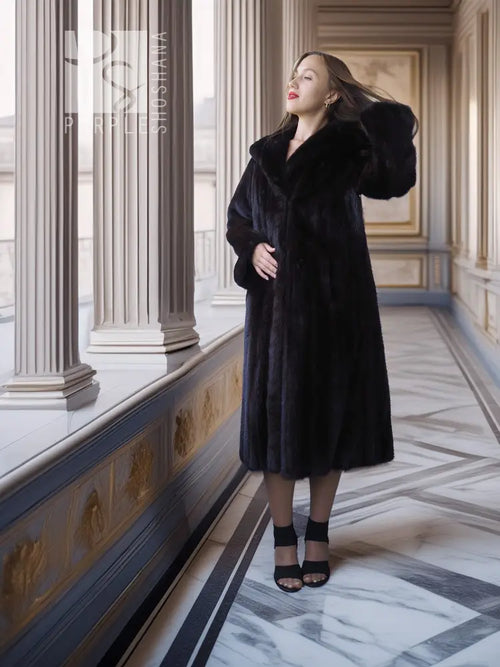Black mink full-length coat with hooded neckline and side-slit skirt hem.
