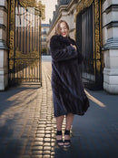 Full-length dark mink coat with plush fur texture and wide, flowing sleeves.