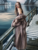 Sleeveless raccoon fur coat styling with open front and taupe-brown fur.