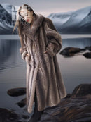 Long raccoon fur coat in taupe-brown with high collar and relaxed fit.