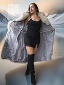 Cream fur-trim long coat opened to show quilted gray lining and hood