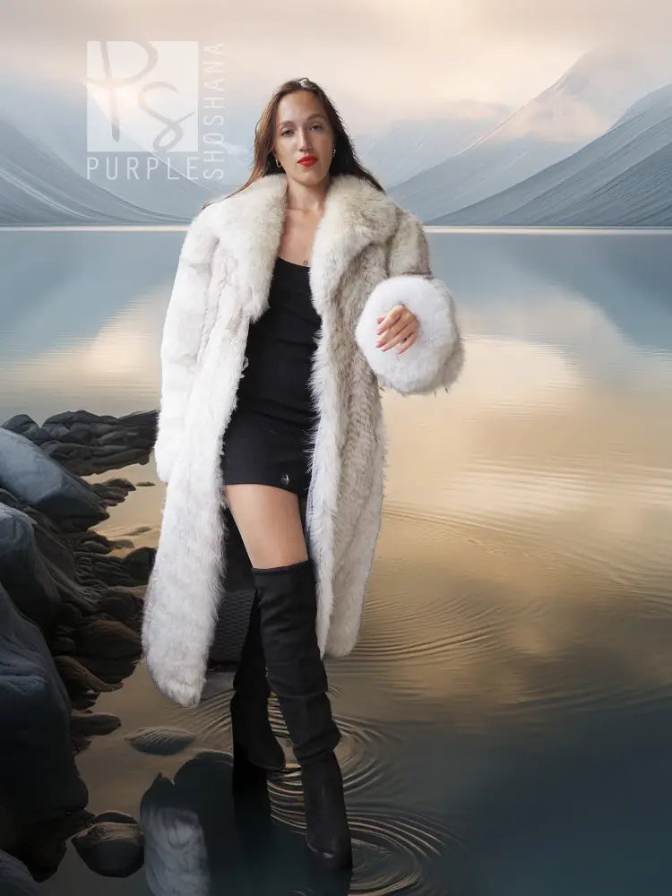 Light-colored fur coat with open wide collar, worn over black dress and tall boots
