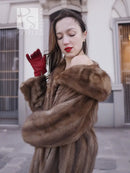 Brown fur coat with wide hooded collar and layered shoulder texture