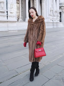 Brown vintage fur coat with hooded collar, long sleeves, and buttonless front