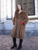 Brown vintage fur coat with hooded collar, long sleeves, and flared hem