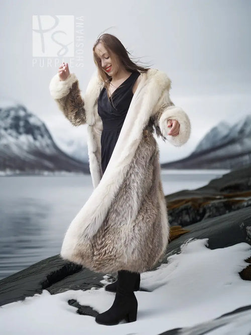 Full-length fur parka with fur-lined hood, cream lining and long coat over black top.