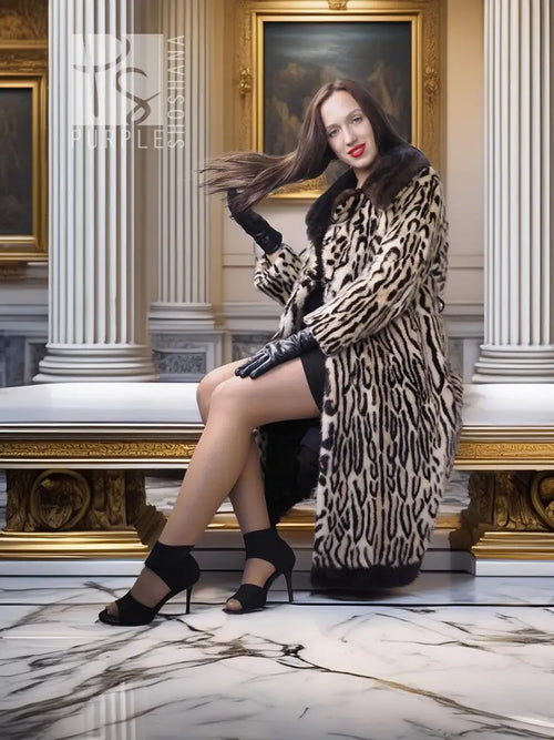 Stenciled mink coat with leopard pattern, black fur collar, belted waist, seated pose