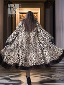 Stenciled mink coat with leopard pattern, wide flare sleeves, black fur trim, back view