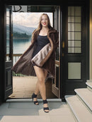 Tan-brown mink swing coat with folded-back cuffs and open front, standing pose.