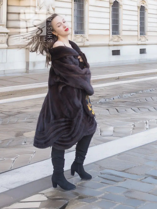 Dark brown mink swing coat with gold baroque trim along inner edge