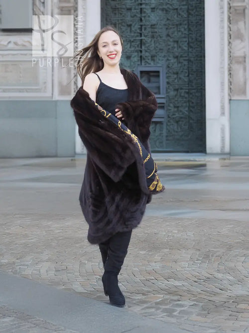 Mink swing coat with dark fur hood, gold baroque lining panels at cuffs and hem