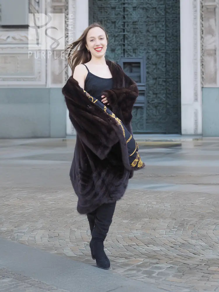 Mink swing coat with dark fur hood, gold baroque lining panels at cuffs and hem