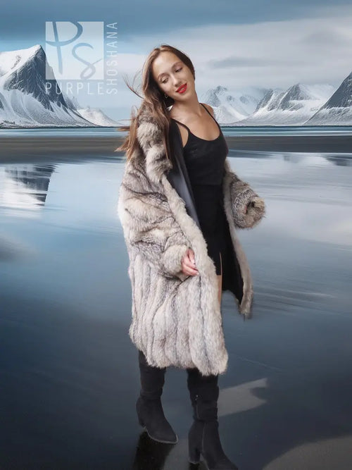 Long faux fur coat with open front and button closure, worn over dark inner top