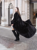Black mink sweep coat with wide fur collar and long sleeves, belted waist