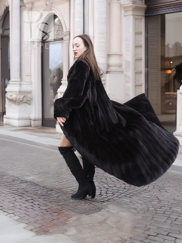 Black mink sweep coat with wide fur collar and long sleeves, belted waist