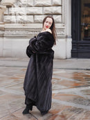 Black mink sweep coat with sculpted fur texture and long collarless neckline