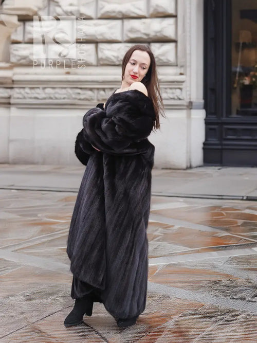 Black mink sweep coat with sculpted fur texture and long collarless neckline