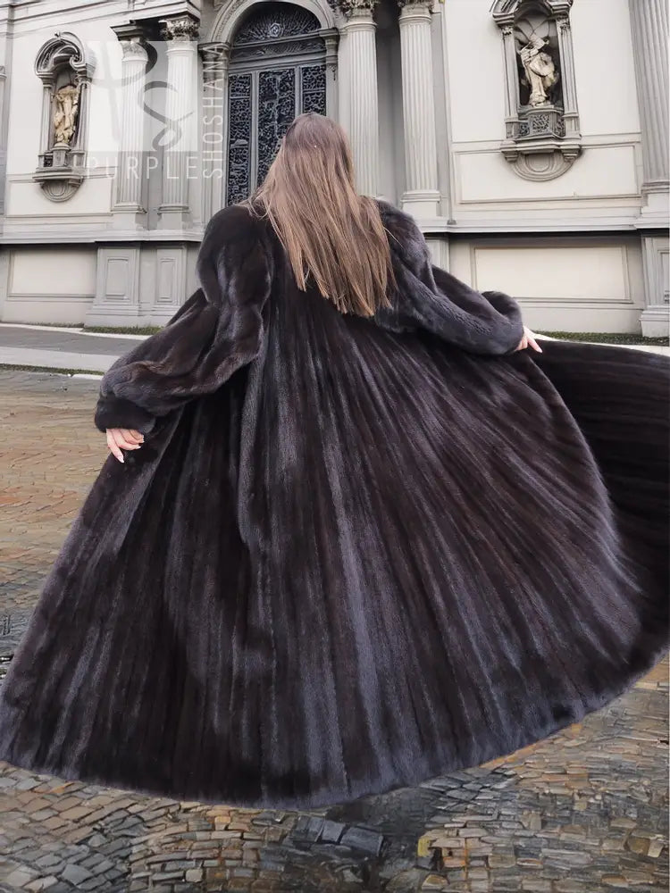Black full-length mink coat with hooded collar and flowing skirt; wide sleeves