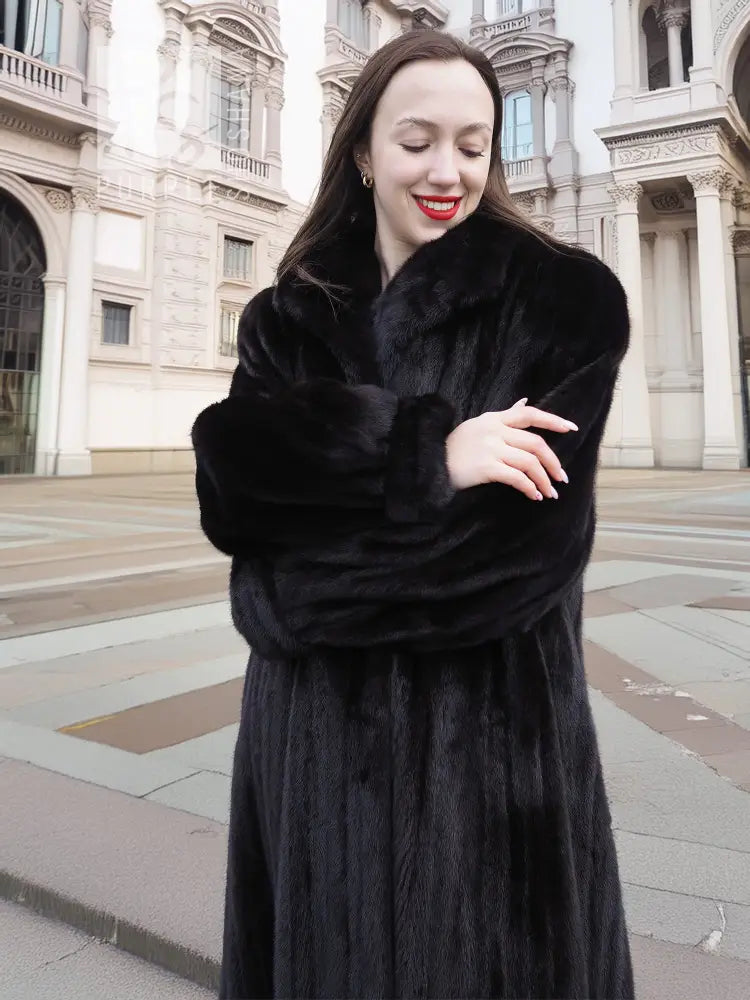 Black mink coat with thick fur sleeves and high collar framing the face