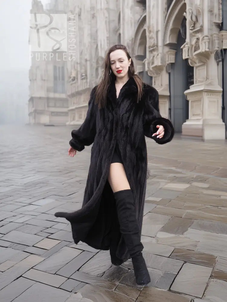 Black mink coat with tie belt, wide collar, and long flared skirt