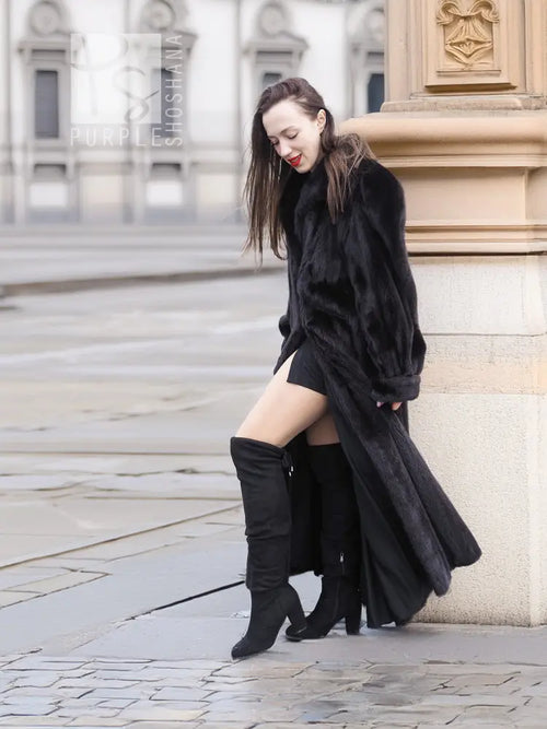 Black mink fur coat with long skirt hem and hooded collar, kneeling side view