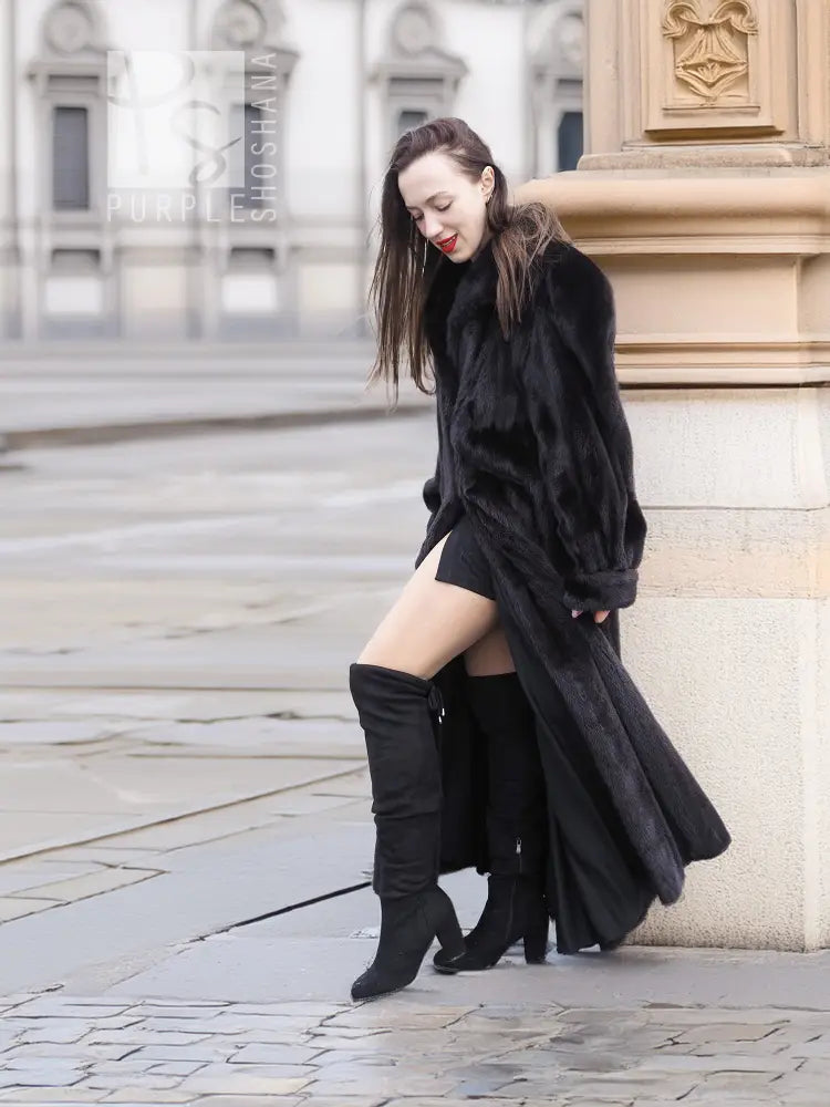 Black mink fur coat with long skirt hem and hooded collar, kneeling side view
