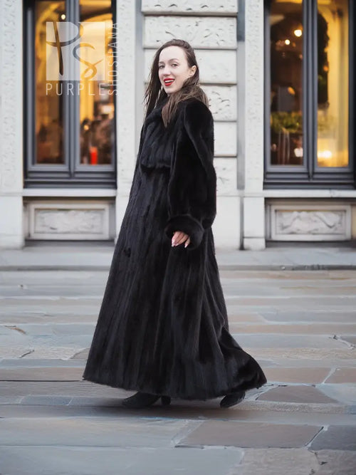 Black mink sweep coat with buttoned front and long, flared hem