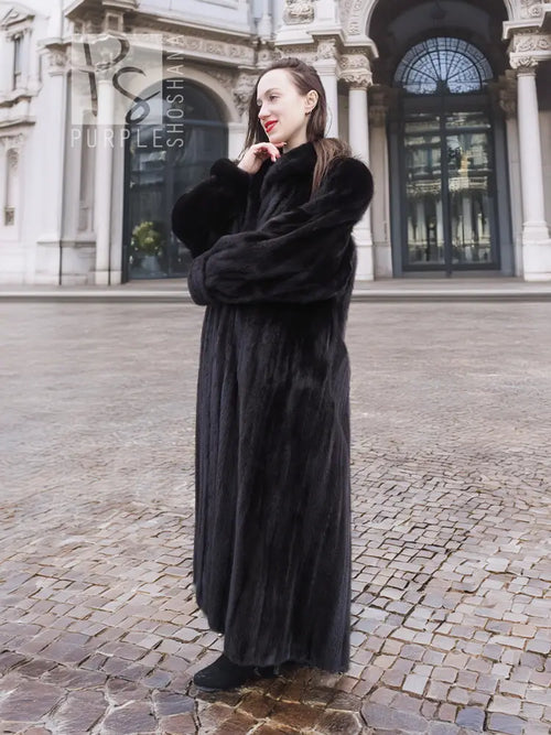 Black mink fur coat with draped hood and belt tie, side view