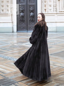 Black mink sweep coat with belted waist and voluminous flare hem
