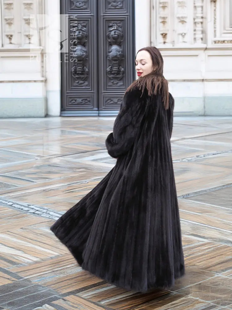 Black mink sweep coat with belted waist and voluminous flare hem