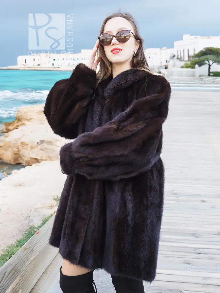 Black mink swing jacket coat with roomy sleeves and button front, close-up front view