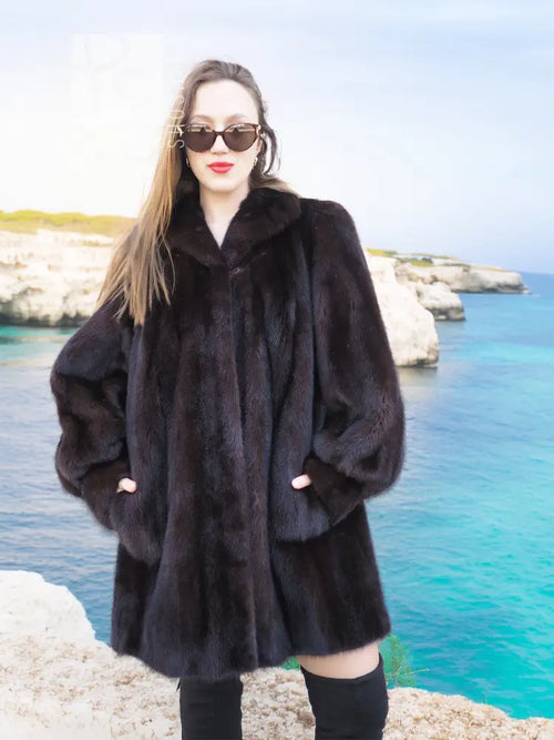 Black mink swing jacket coat with button front, wide collar, and long puff sleeves